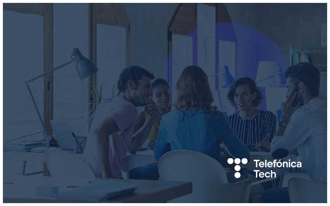 Team of professionals collaborating around a meeting table in a modern office environment, overlaid with a blue brand filter and Telefónica Tech logo. The image conveys teamwork, innovation, workplace collaboration, and digital transformation in a business setting.