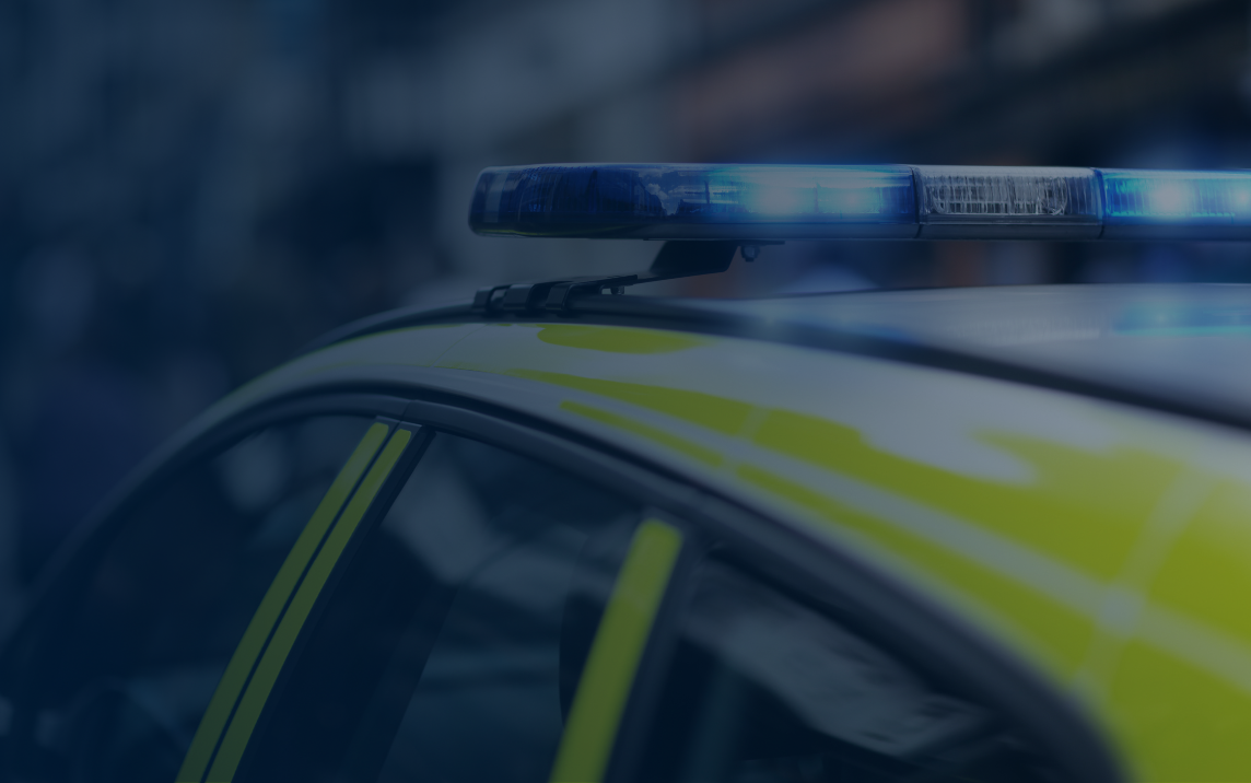Police car with blue emergency lights activated, representing urgent police action under Clare’s Law to prevent domestic abuse.