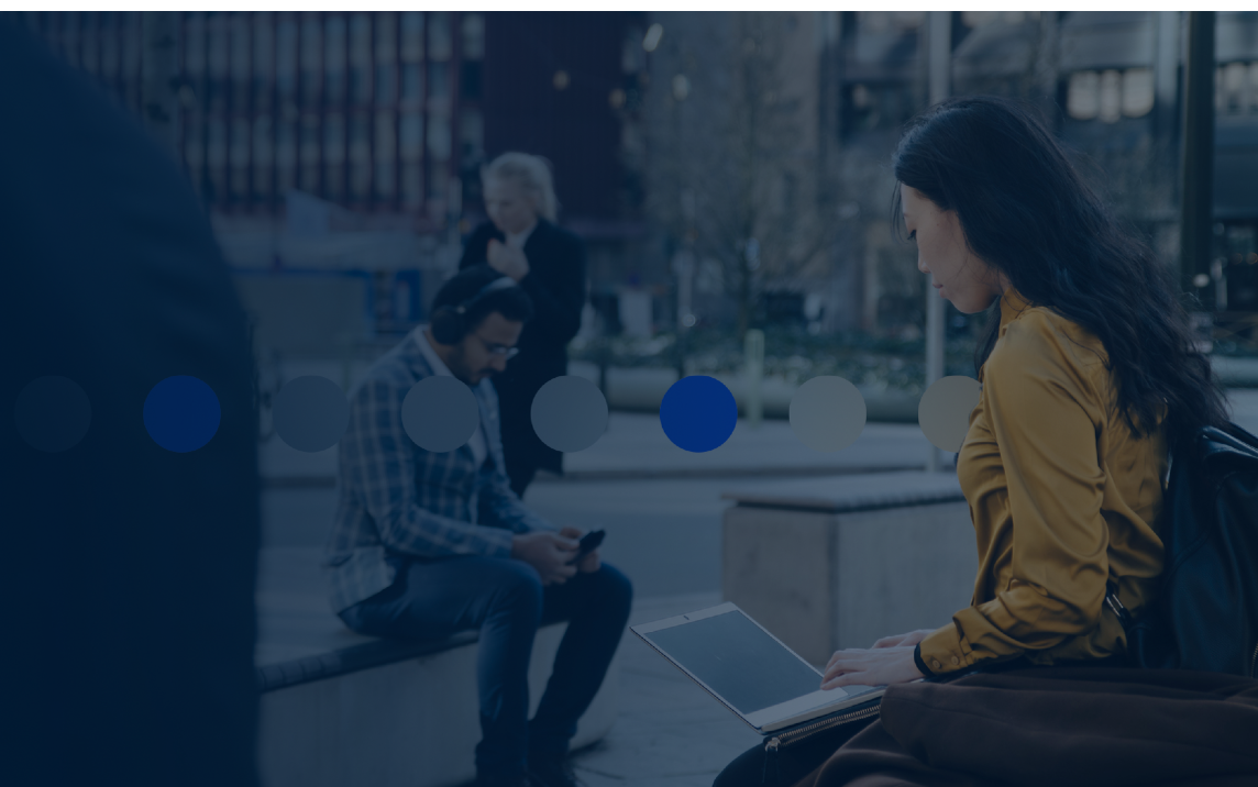 Professional using a laptop in a city environment representing responsible data use and AI governance in modern organisations.