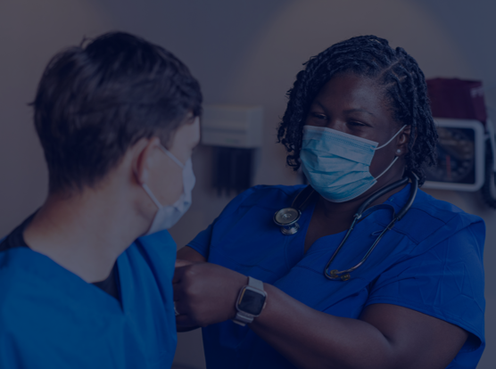 The image shows two healthcare professionals interacting with eachother