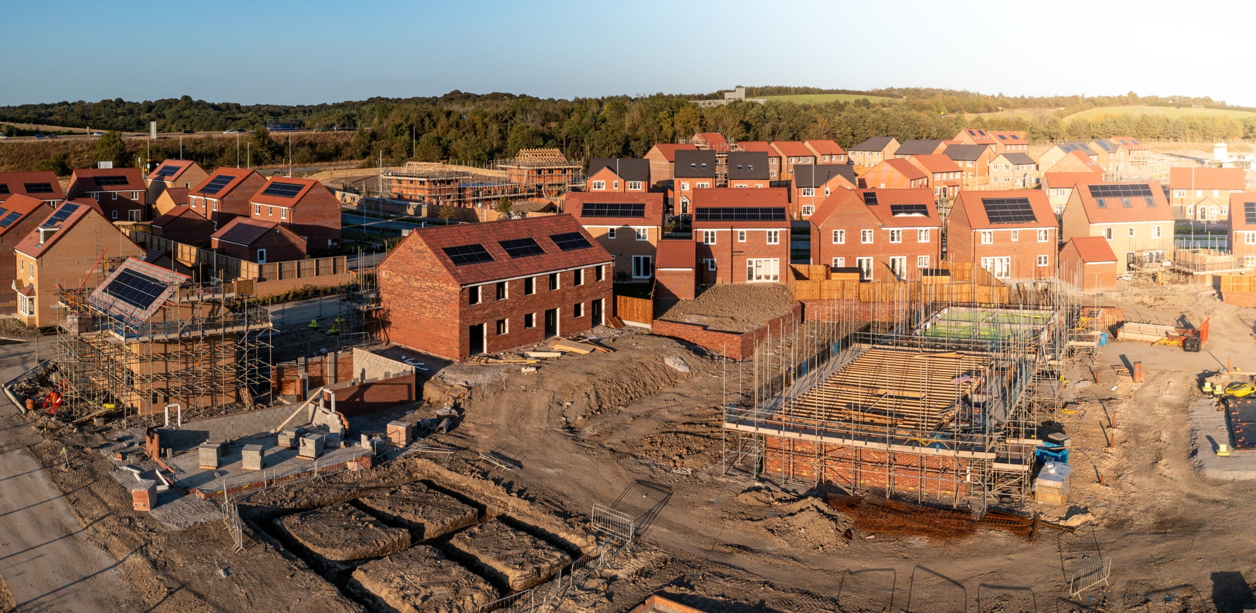 Aerial panoramic landscape view of a new build housing estate with houses under construction to fill the gap in the UK home shortage and supplement the UK Government's Right To Buy policy