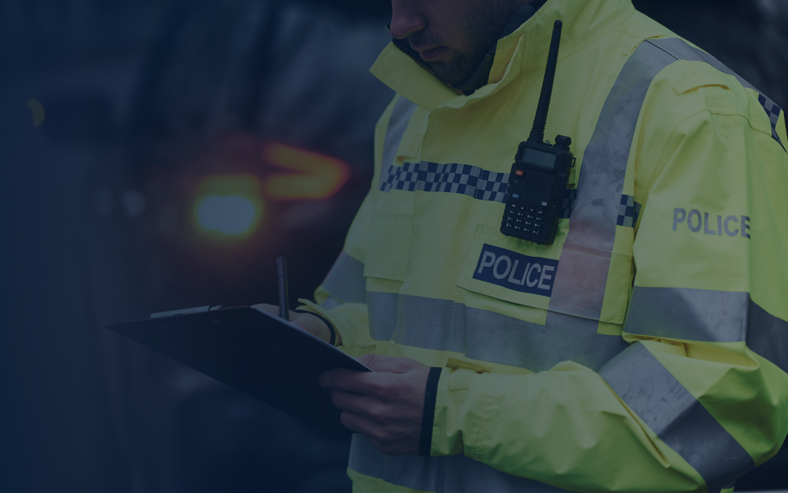 Police officer completing safeguarding paperwork during a domestic abuse enquiry under Clare’s Law