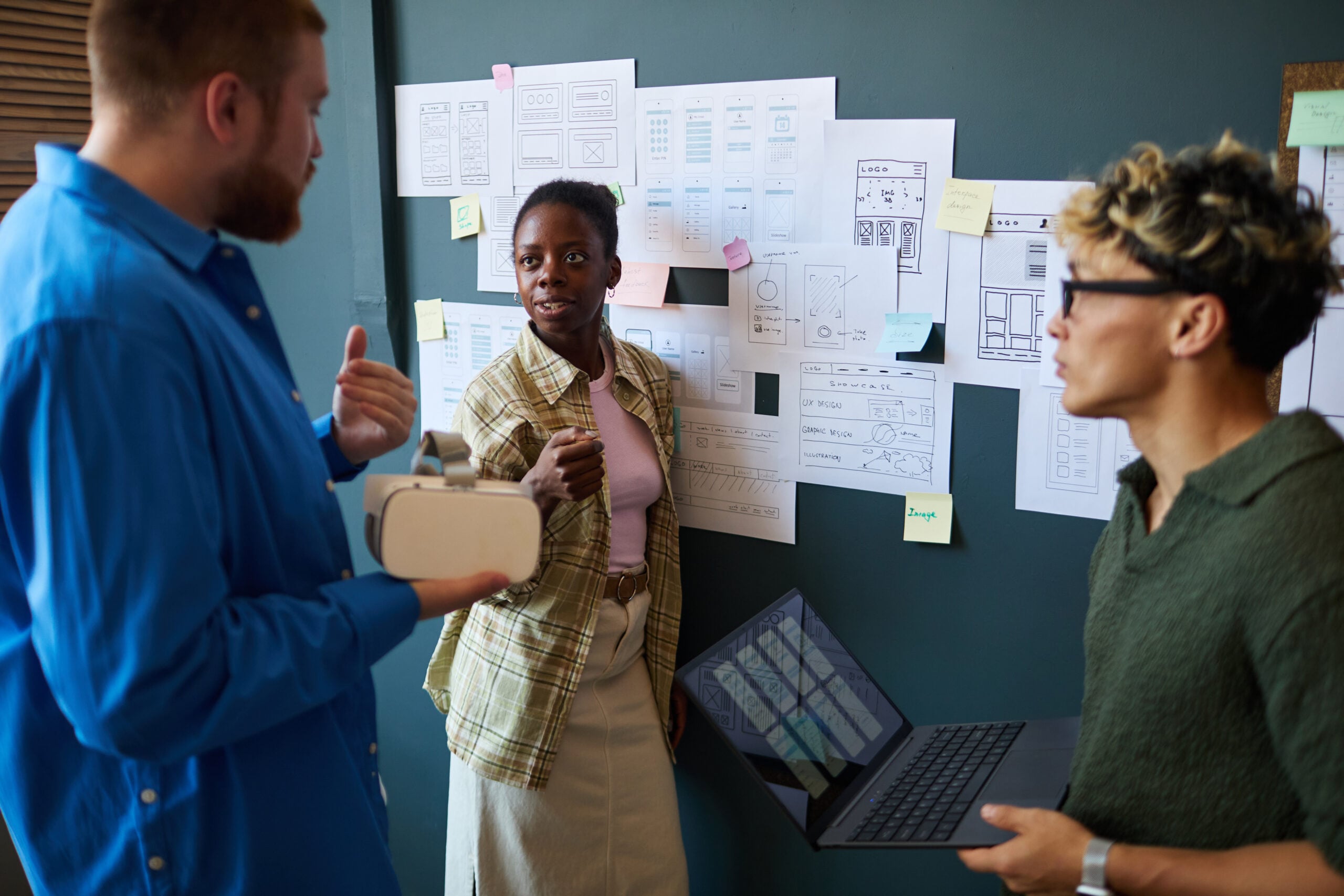 Team collaborating on AI pilot delivery and reviewing solution performance on laptop