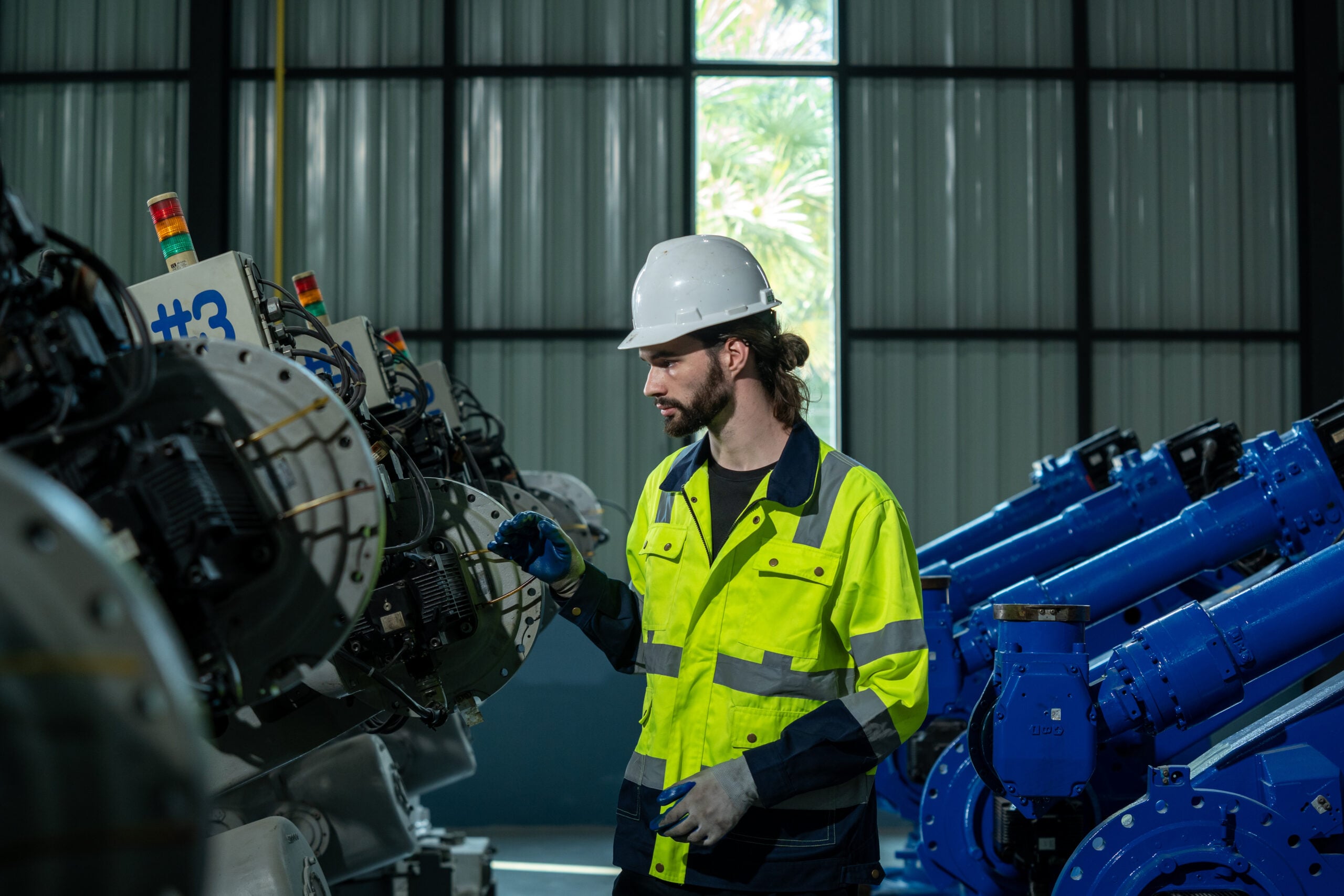 Engineer inspecting industrial machinery as part of AI and predictive maintenance strategy