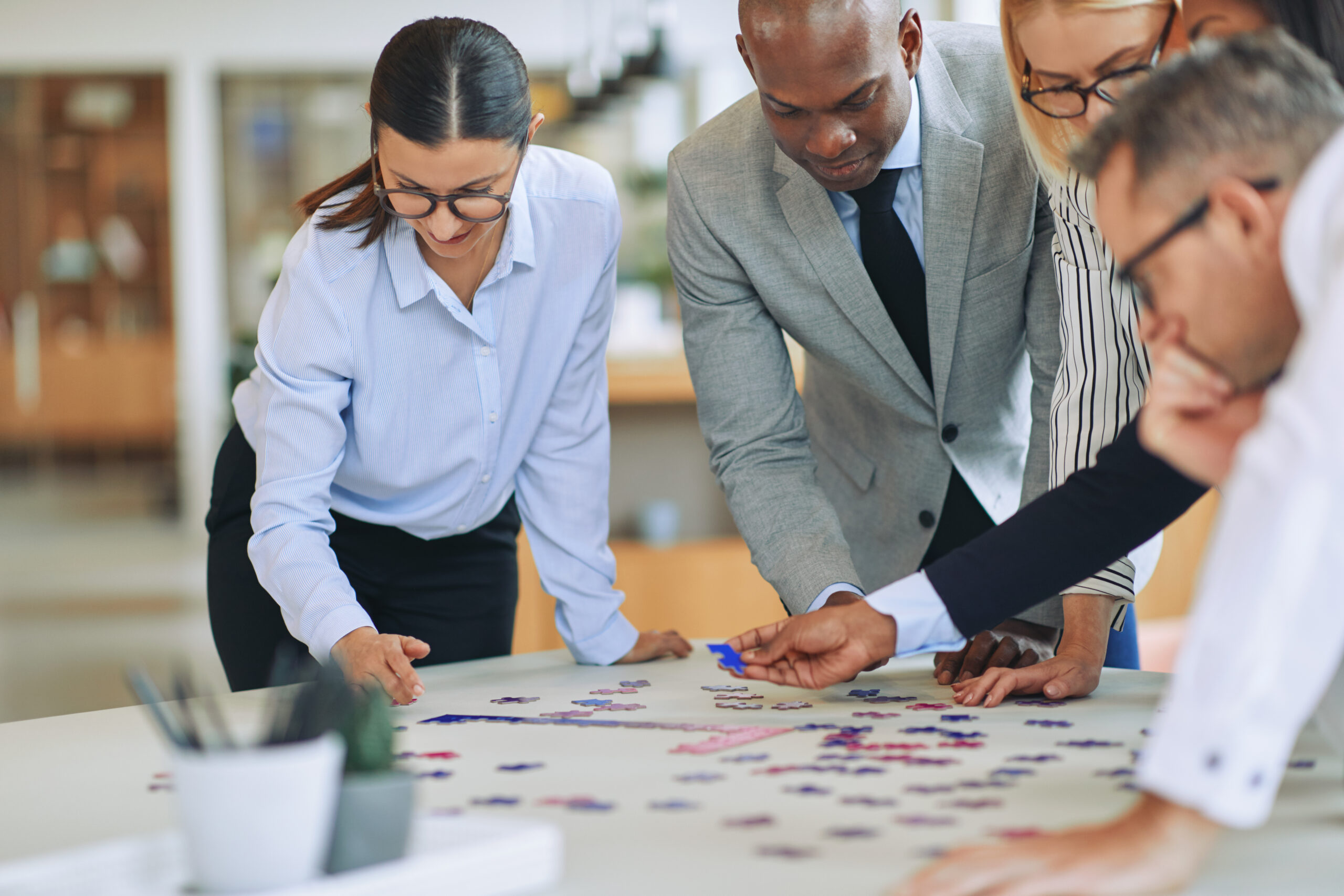 Business team collaborating to solve challenges during AI solution envisioning process