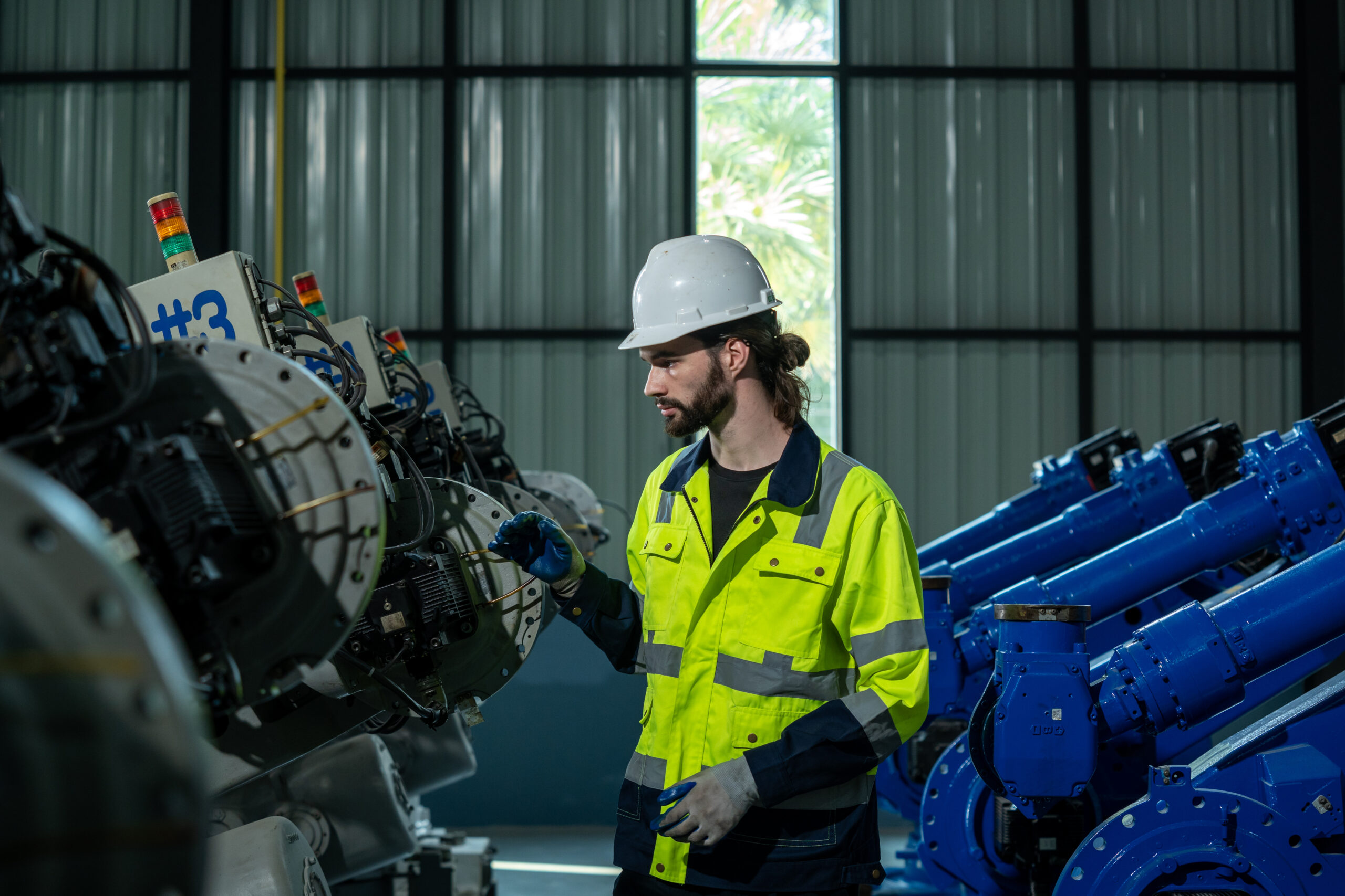 Engineer inspecting industrial machinery as part of AI and predictive maintenance strategy