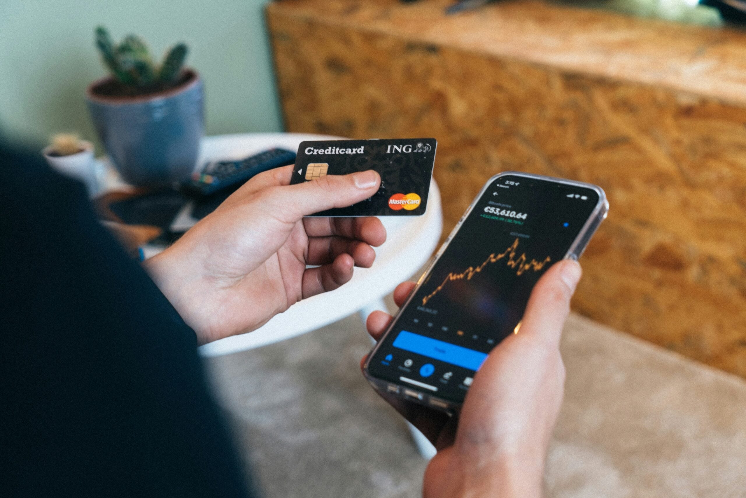 Fraud Detection - person paying on their phone with their credit card.