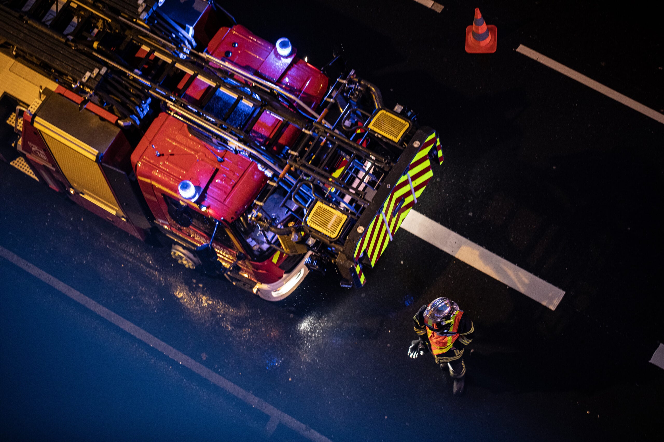 Firefighter working alongside an emergency response vehicle