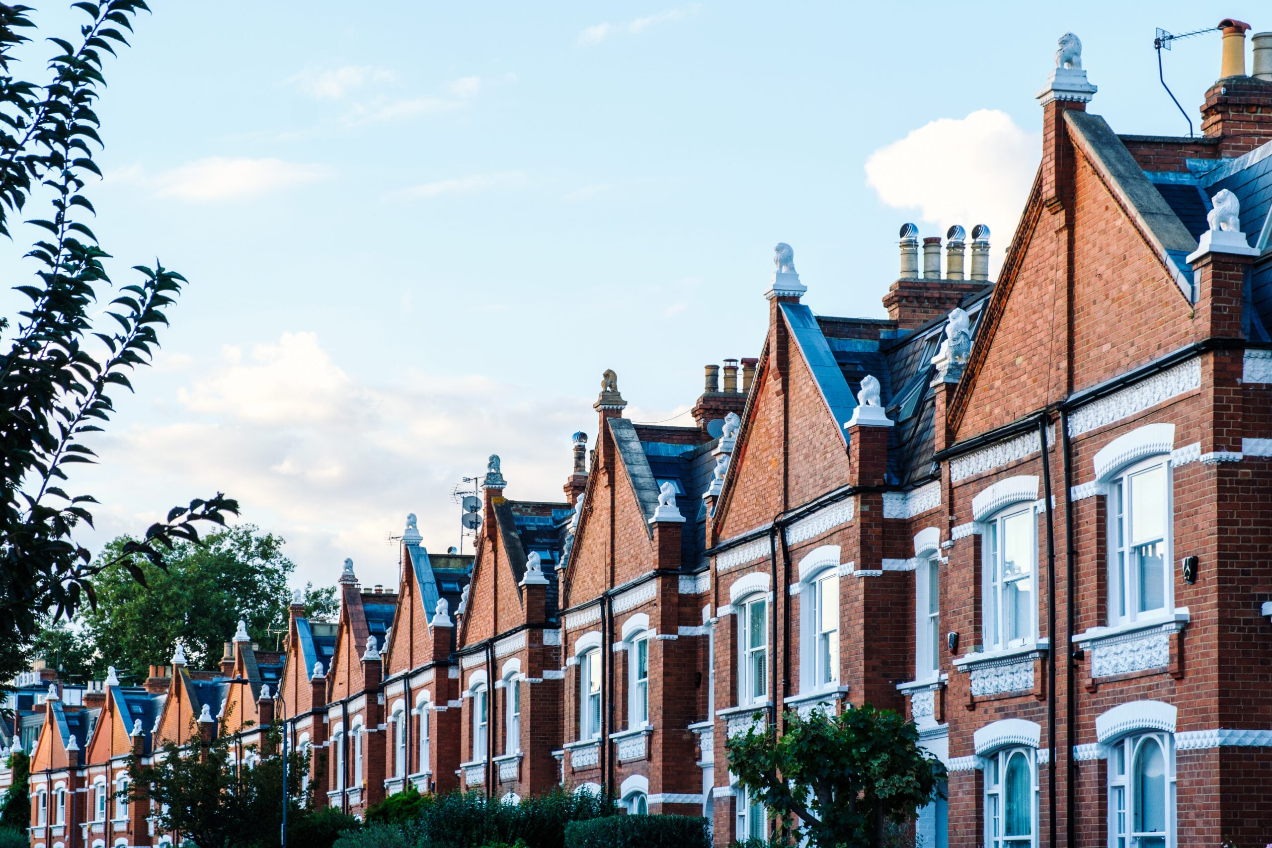 Row of traditional red-brick terraced houses representing housing and local communities