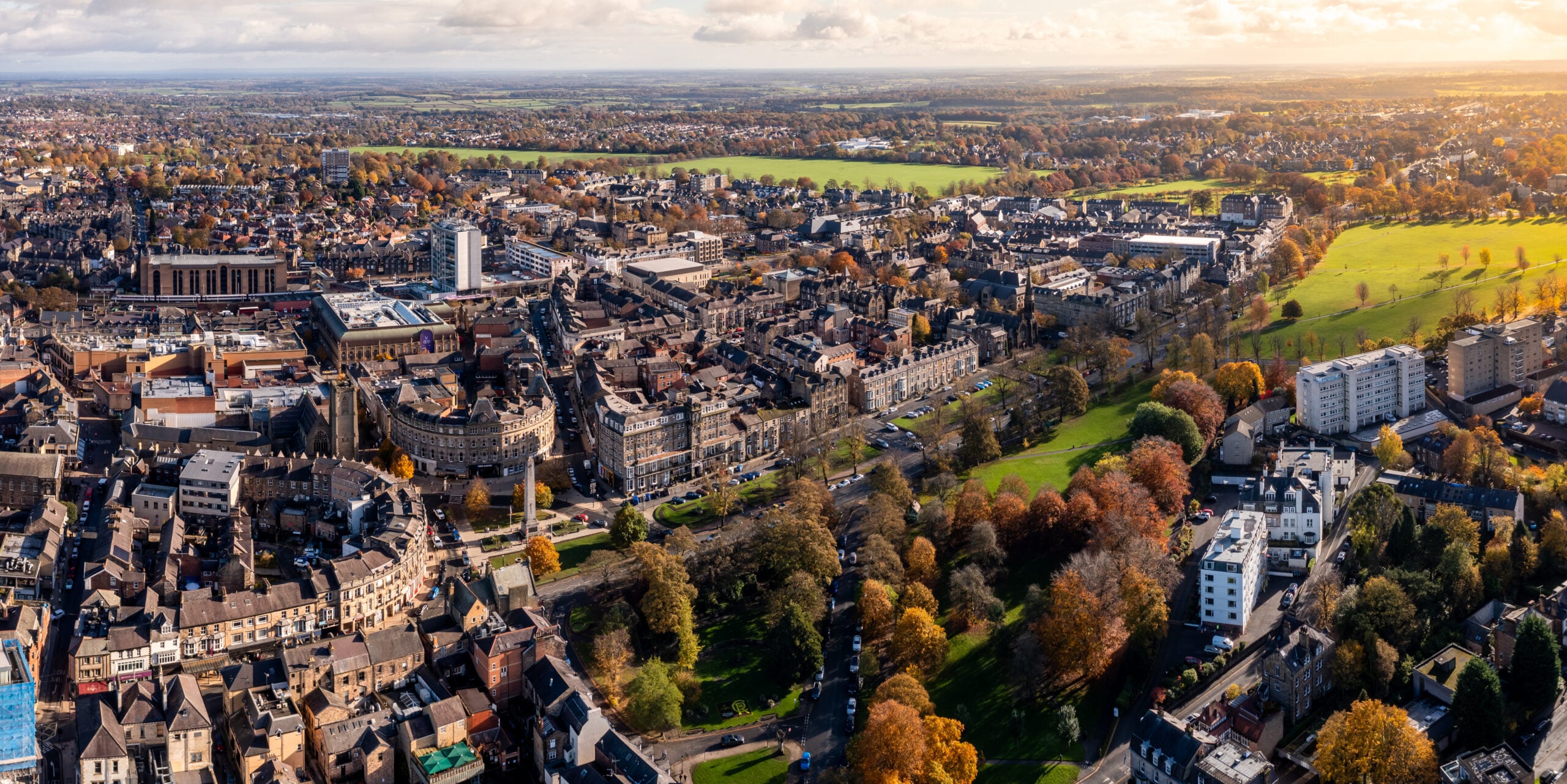 Aerial view of a UK town with residential areas, public spaces and green parkland