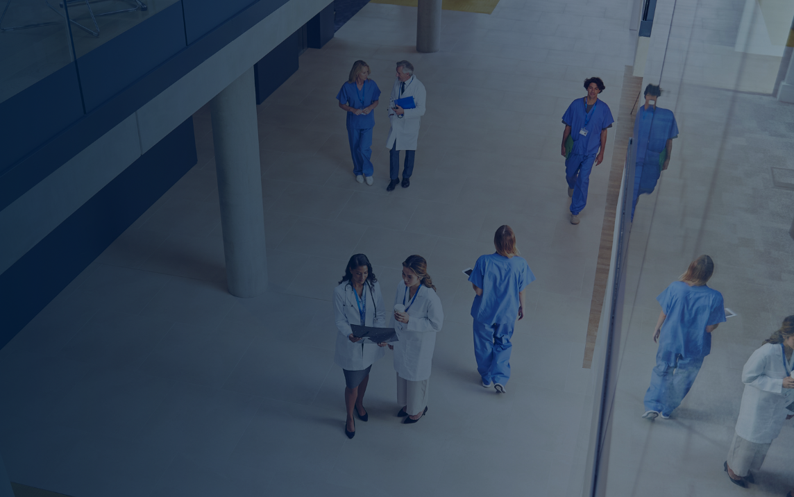 Healthcare professionals collaborating in hospital atrium using NHS Federated Data Platform insights
