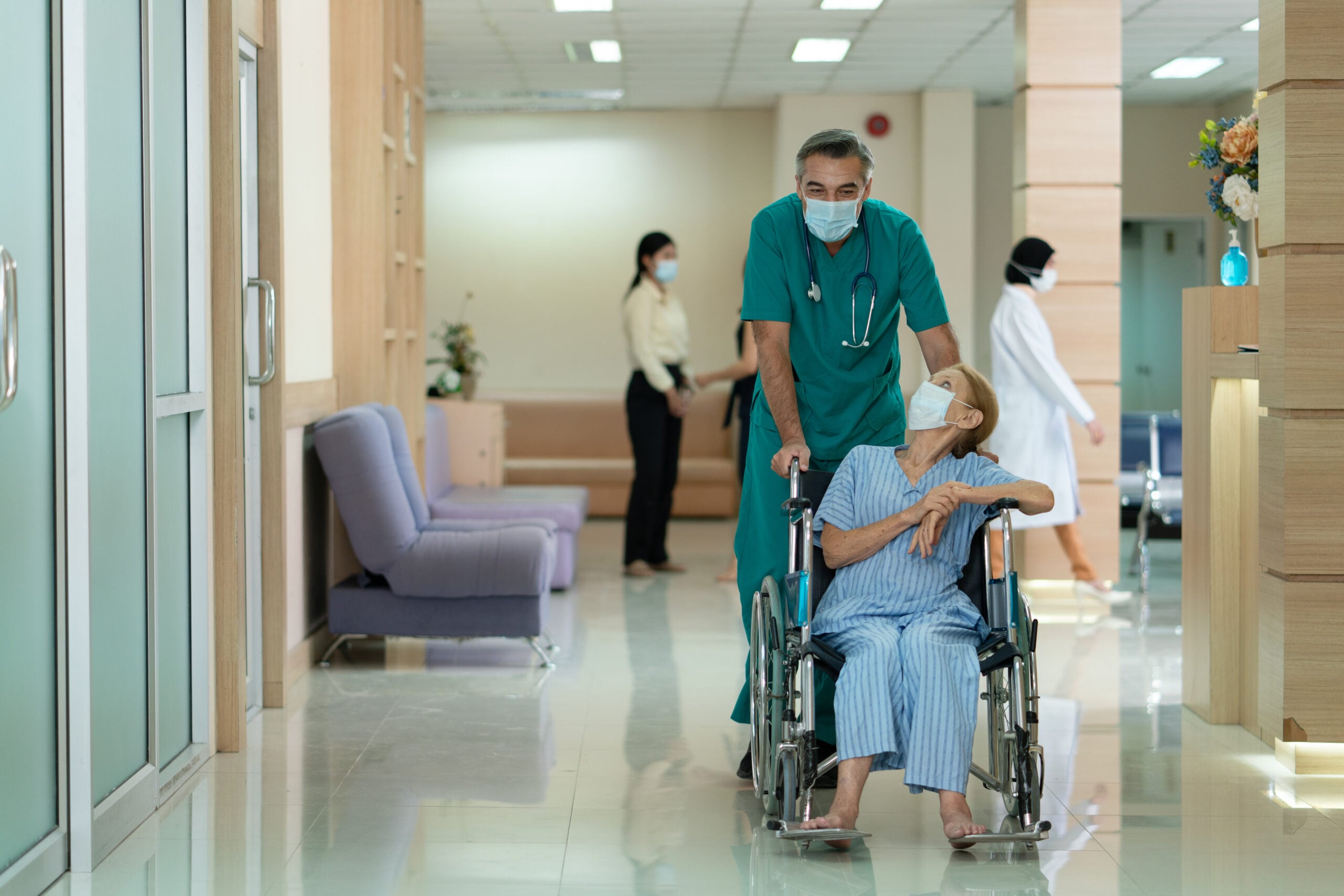 Healthcare professionals collaborating in hospital atrium using NHS Federated Data Platform insights