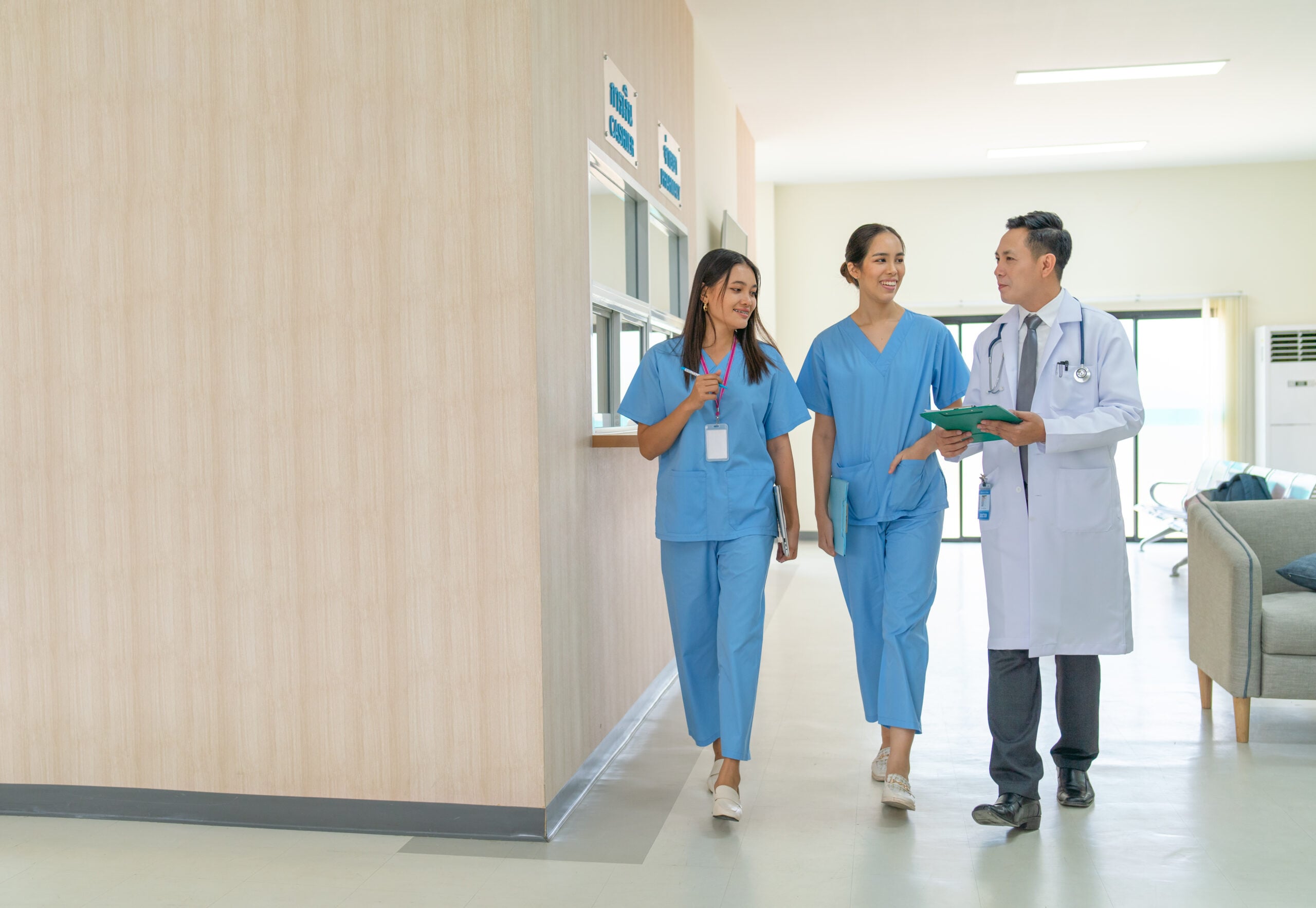 Doctors reviewing patient data on tablet in hospital NHS Federated Data Platform usage