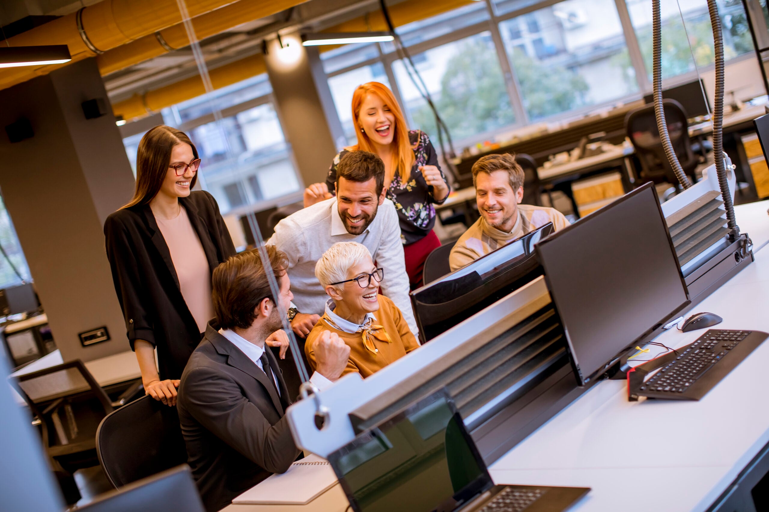Senior businesswoman working together with young business people in the modern office
